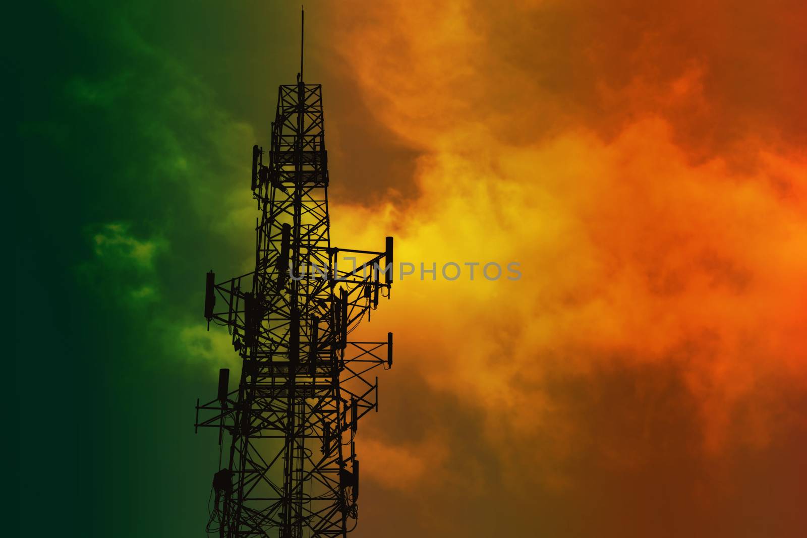 silhouette antenna and night green orange heap cloud on sky