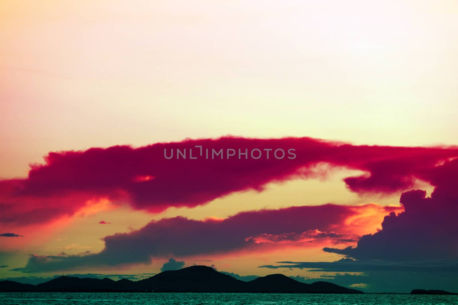 sunset on the sea and colorful flame cloud cold sky silhouette island