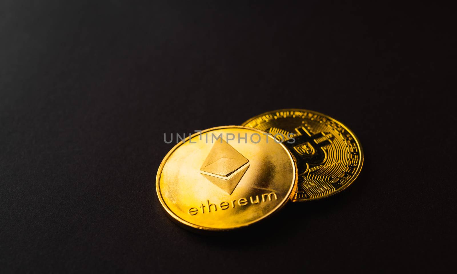Golden ether coins or Ethereum network exchange on black background, blockchain and money cryptocurrency (crypto currency) concept