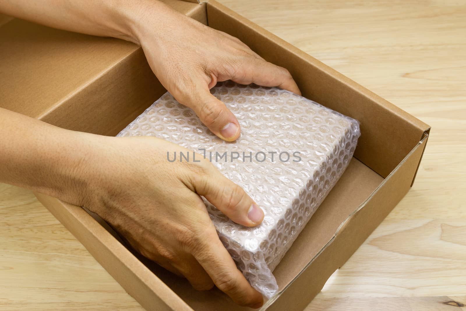 hand of man hold bubble wrap, for protection parcel product cracked or insurance During transit  