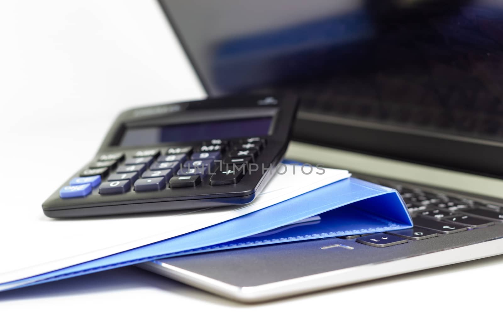 Close Up Blue file folder and Laptop Computer on desk in meeting room by piyaphun