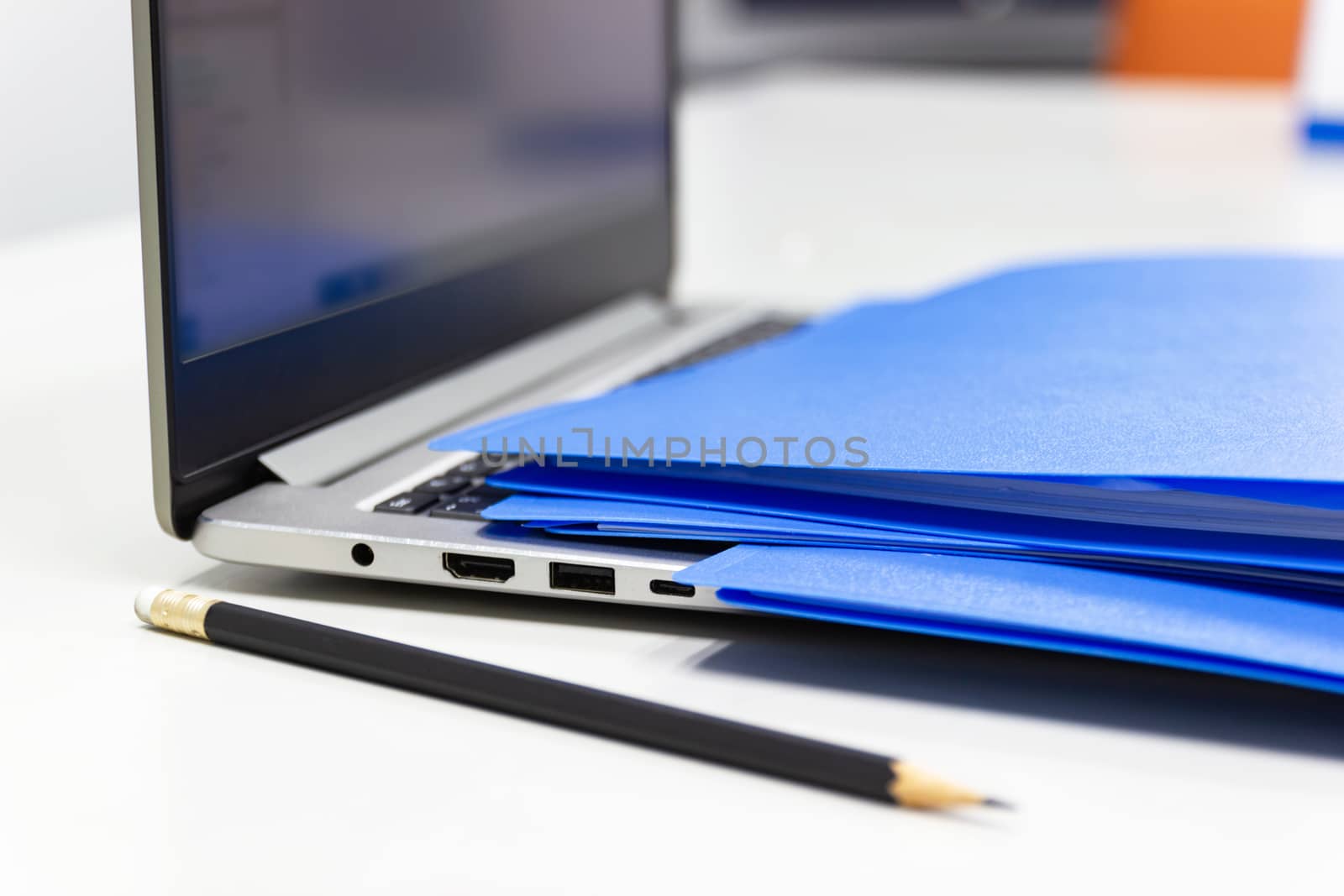 Close Up Blue file folder and Laptop Computer on desk in meeting room, business concept at work office.