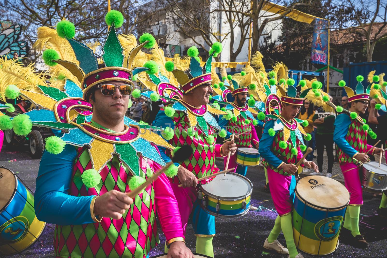 Loule, Portugal - February 25, 2020: percussionists parading in the street accompanying dancers in the parade of the traditional carnival of Loule city on a February day