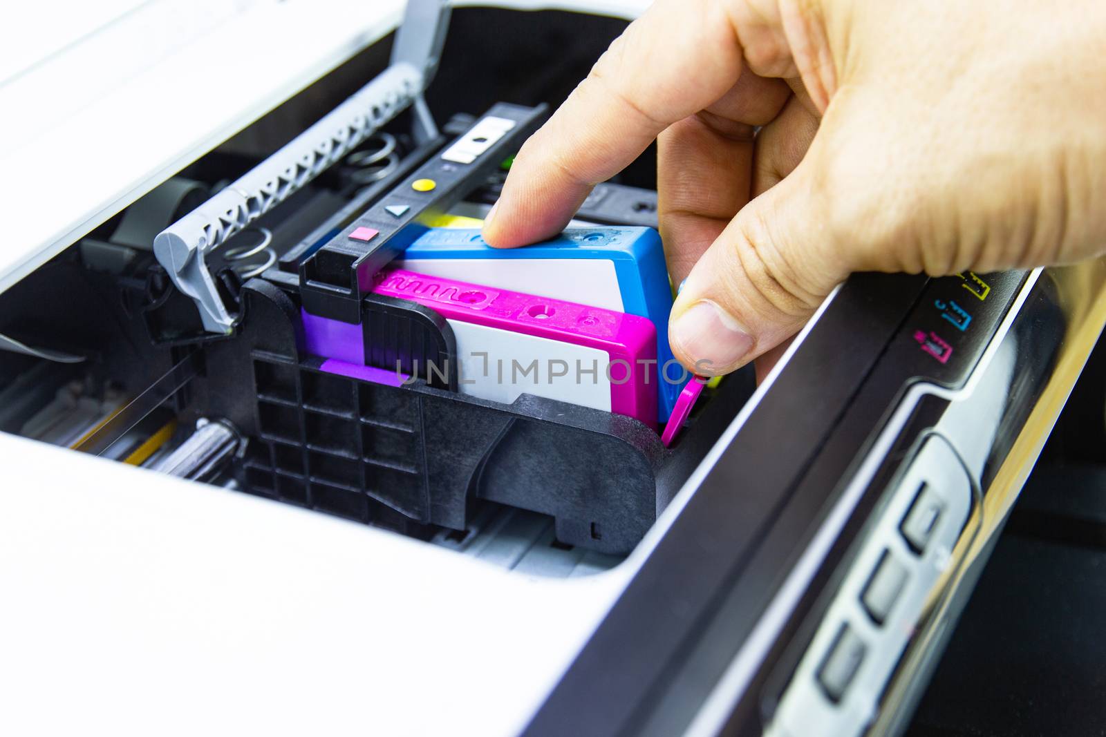 Technicians are install setup the ink cartridge of a inkjet printer the device of office automate for printing