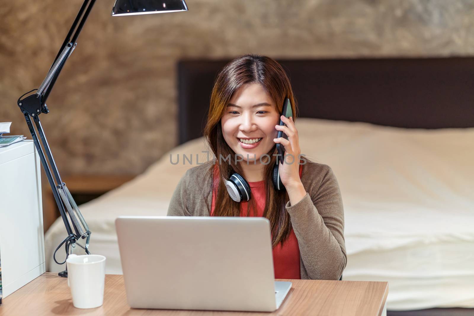 Asian business woman using technology laptop and working from home in bedroom, video conference and calling,startups and business owner,lifestyle occupation,social distancing and self responsibility