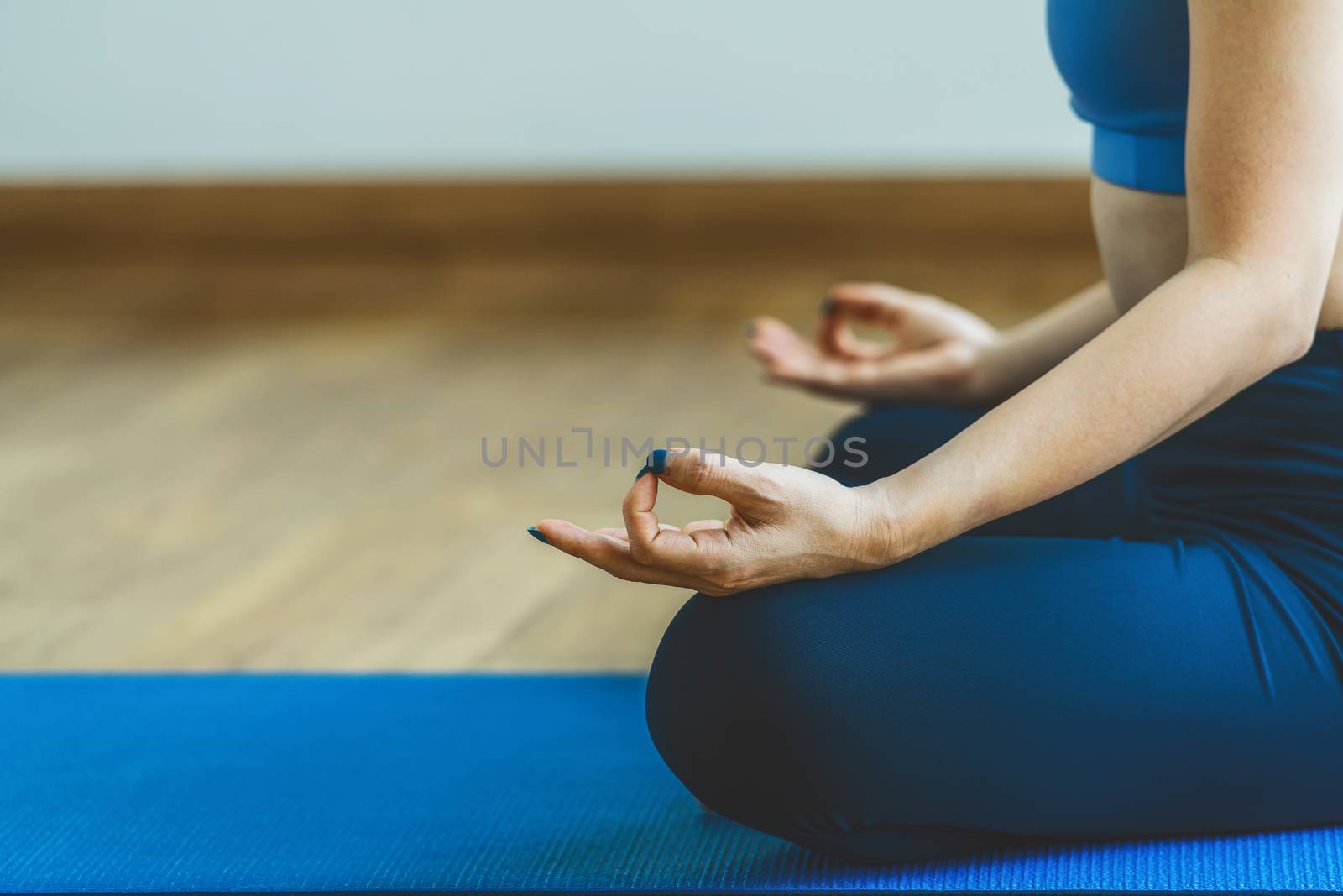 Asian woman practicing yoga from home when Covid19 outbreak and by Tzido