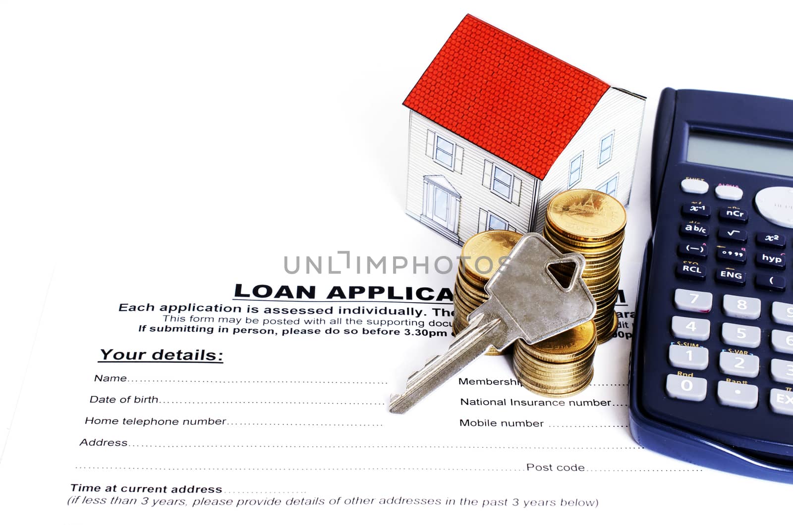 Home key with coins stack and paper house and calculator on Loan application form for Mortgage loan concept