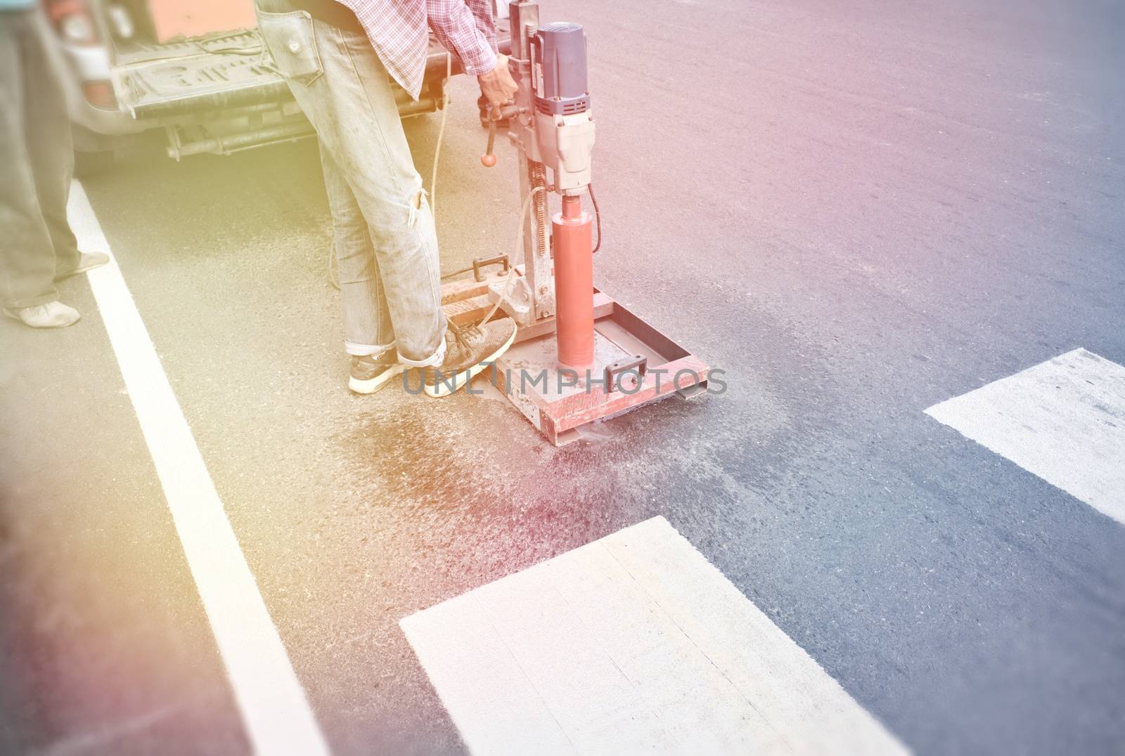 Drilling work for asphalt surface thickness, white zebra crossing and sunlight by ChaiyootWilipun883