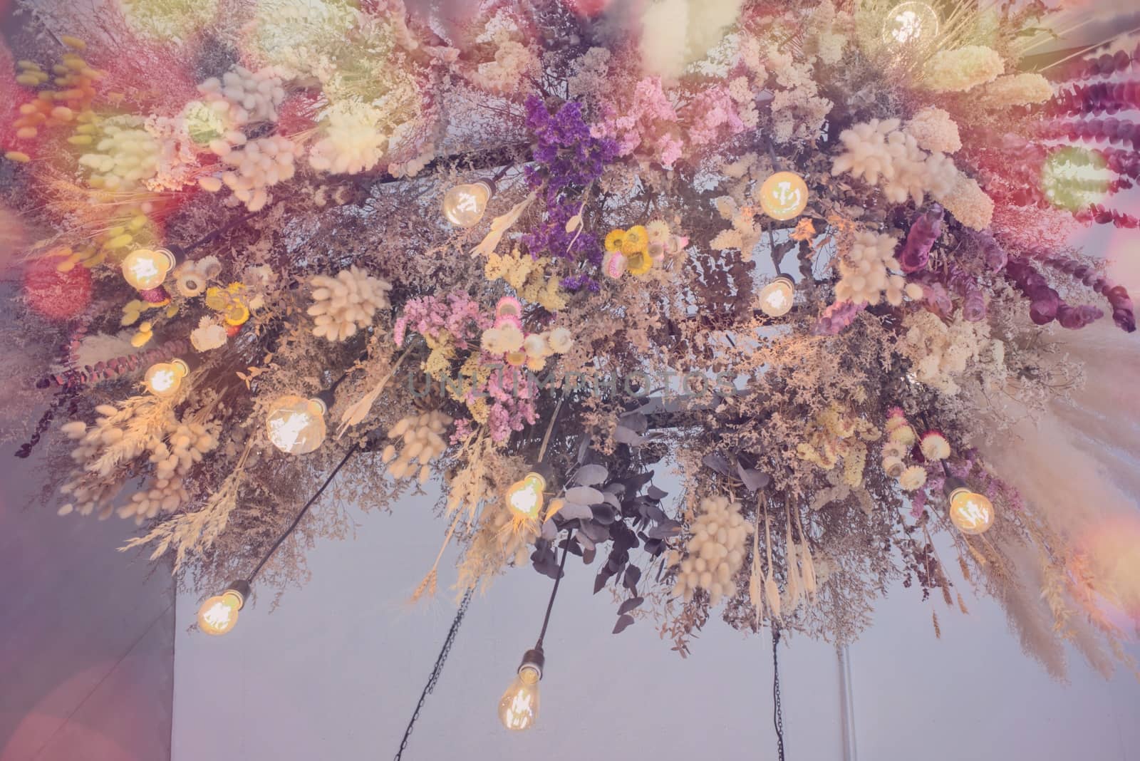 chandelier of flowers on ceiling.Orange bulb light by ChaiyootWilipun883