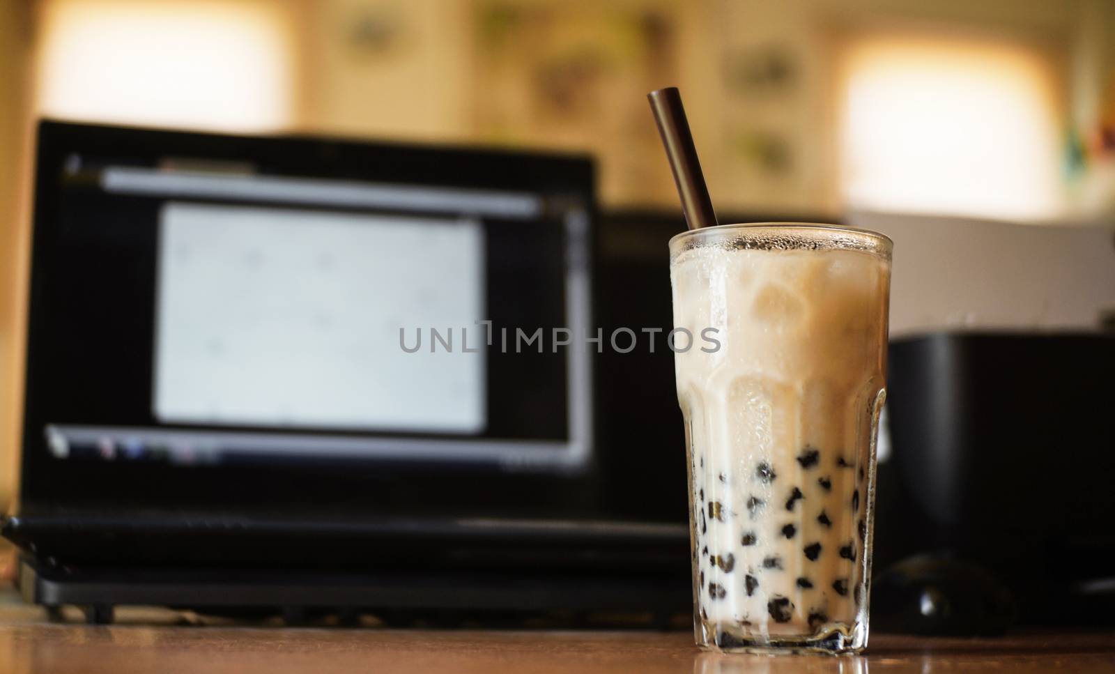 A glass of bubble tea on table, work from home.