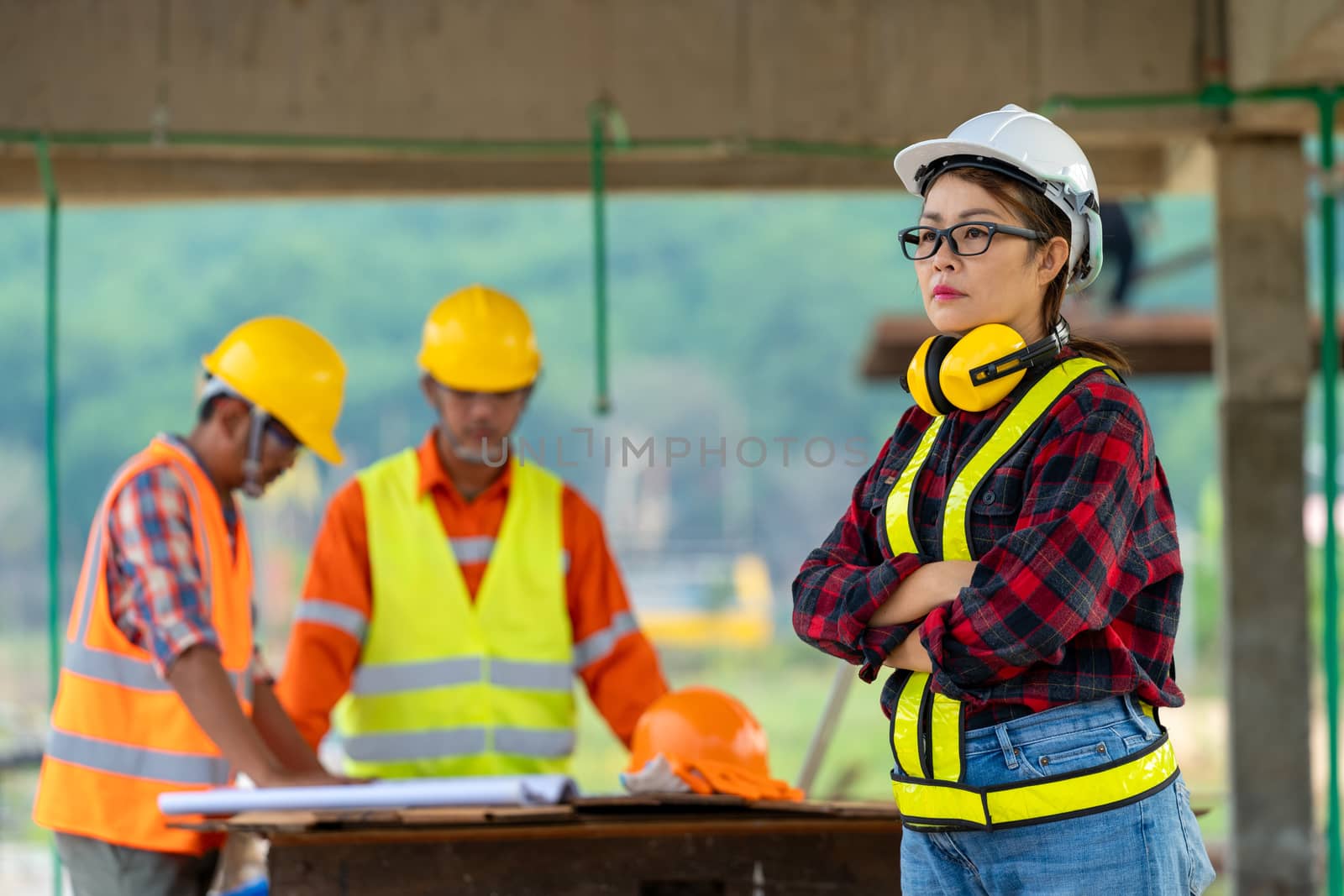 Female construction site engineer,Portrait of confident female construction worker at construction site.
