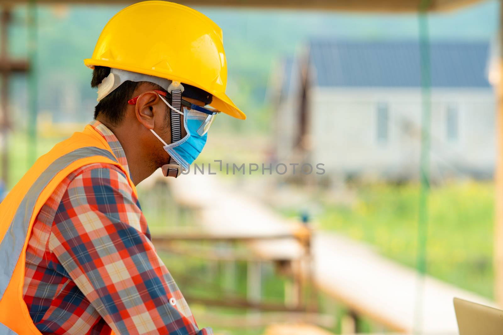 Construction worker wearing protective mask by Visoot