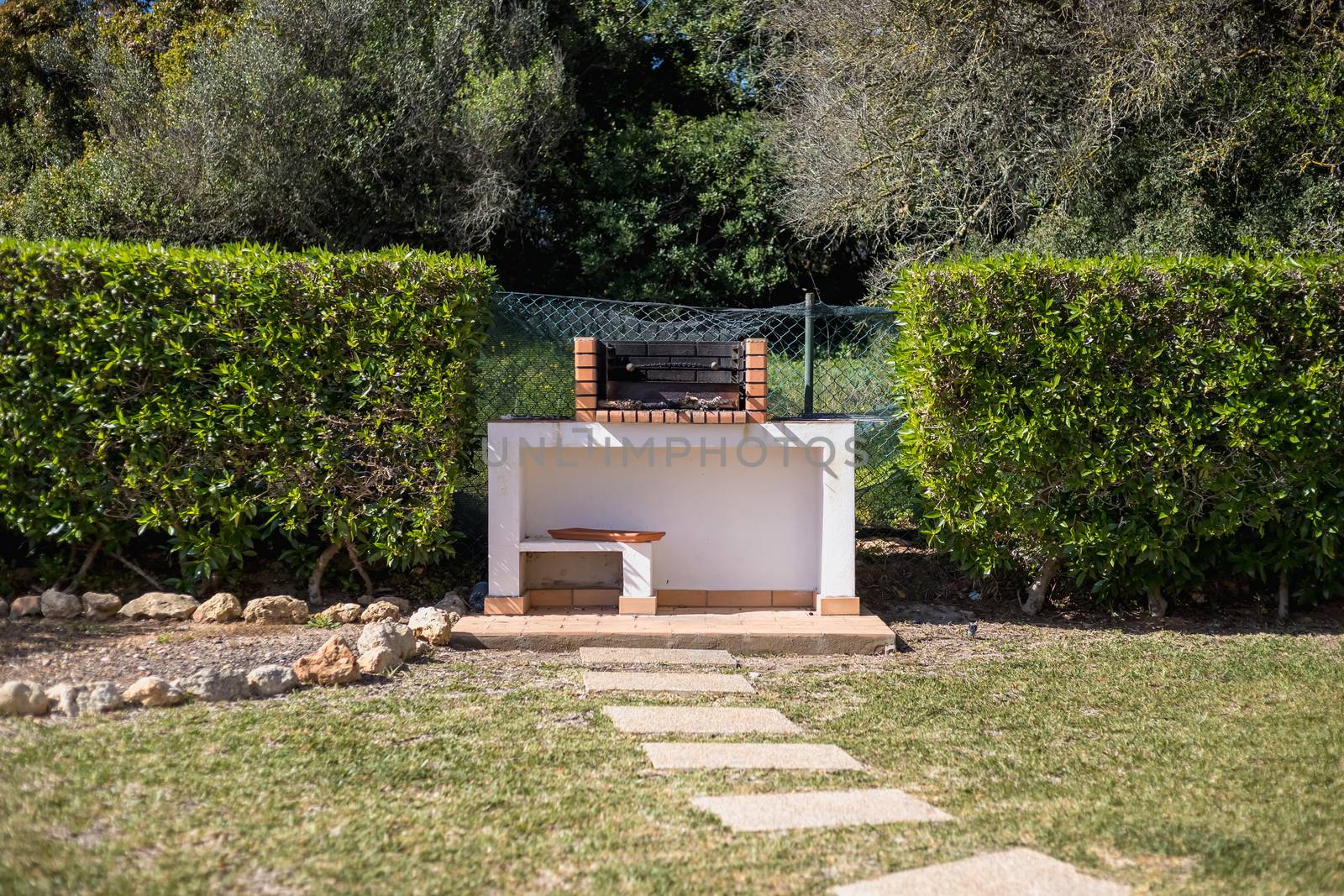 Charcoal barbecue in red brick in a garden in Portugal