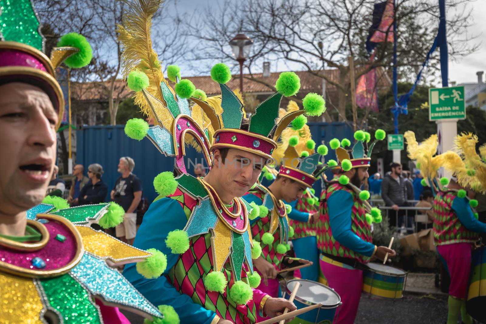 Loule, Portugal - February 25, 2020: percussionists parading in the street accompanying dancers in the parade of the traditional carnival of Loule city on a February day