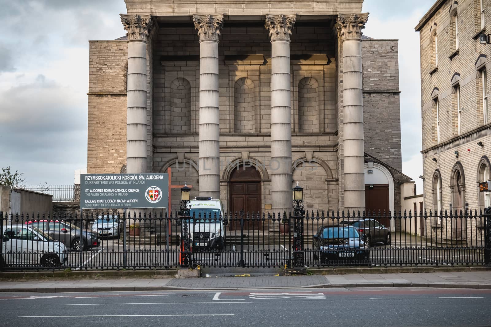 Dublin, Ireland - February 13, 2019: Street atmosphere and architecture of St. Audoen's Roman Catholic Church that people visit on a winter day