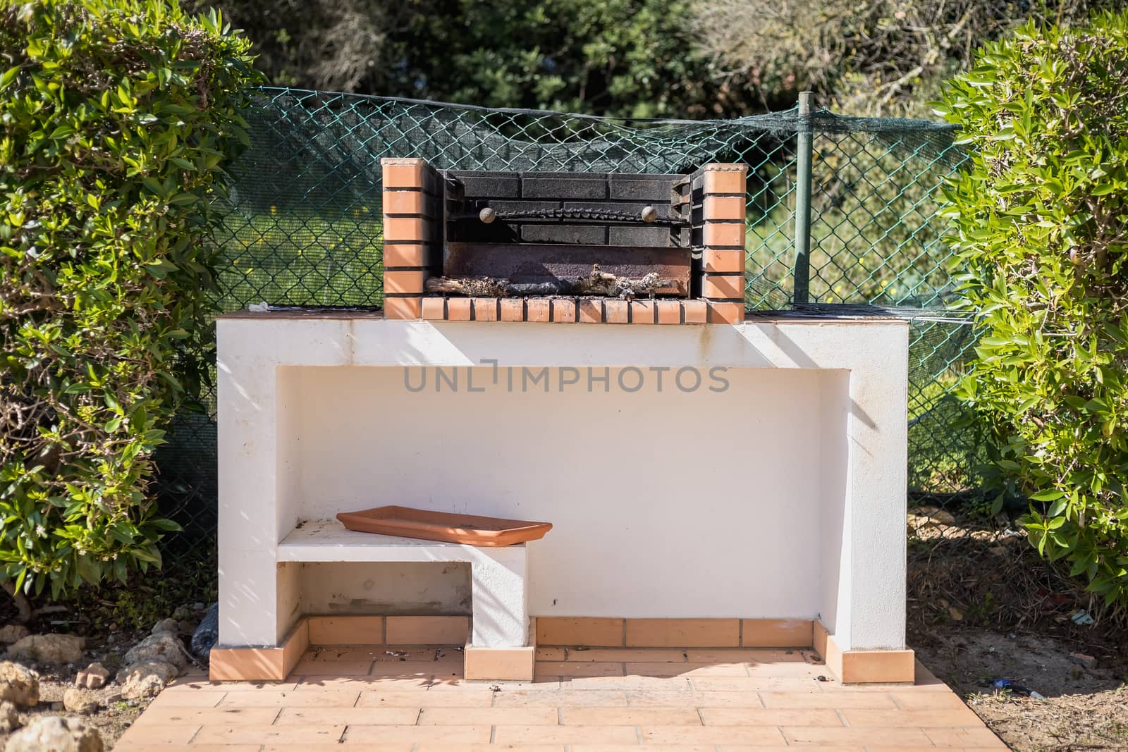 Charcoal barbecue in red brick in a garden by AtlanticEUROSTOXX