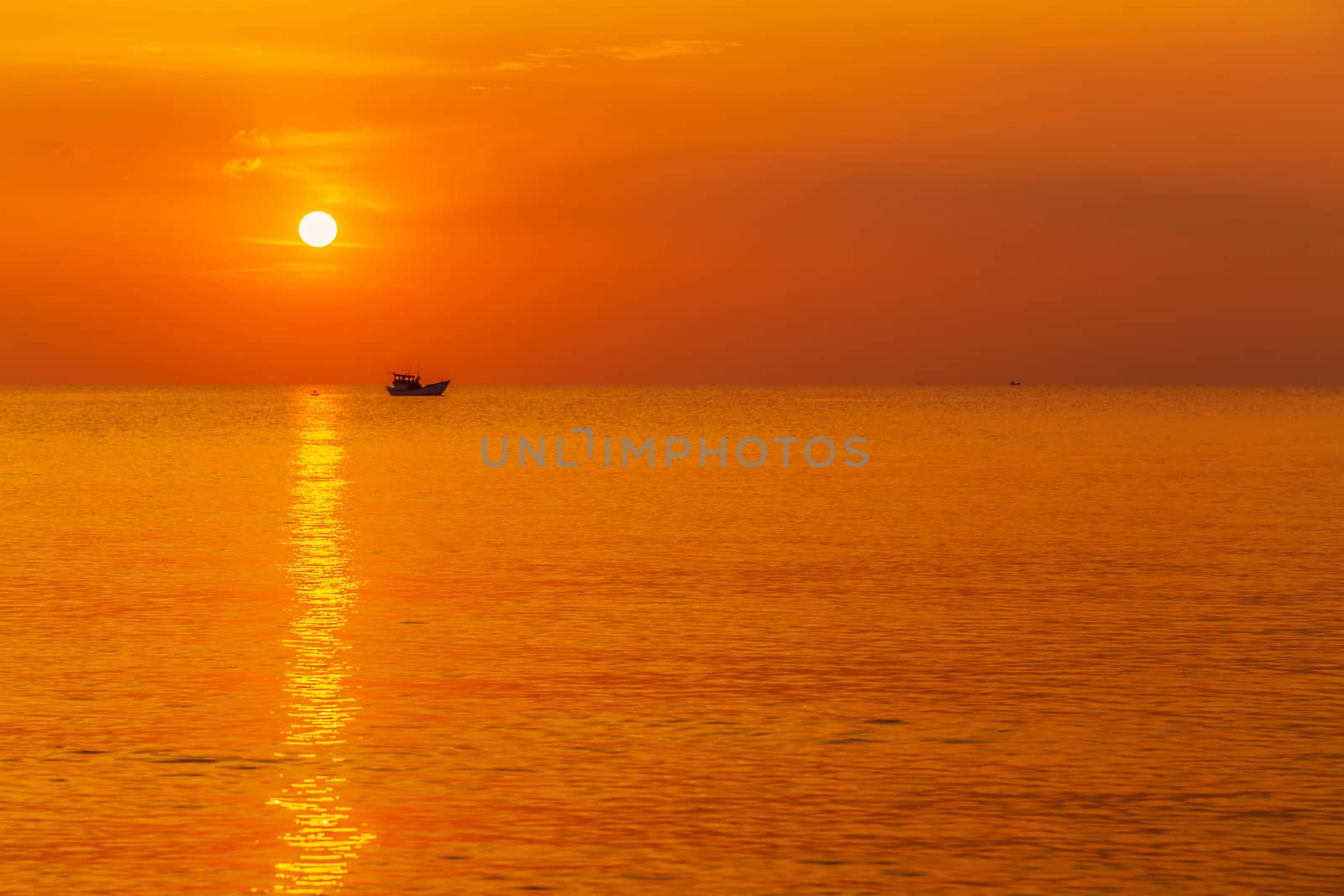 Sea wave beautiful sunset cloudscape. fishing boat in the sea