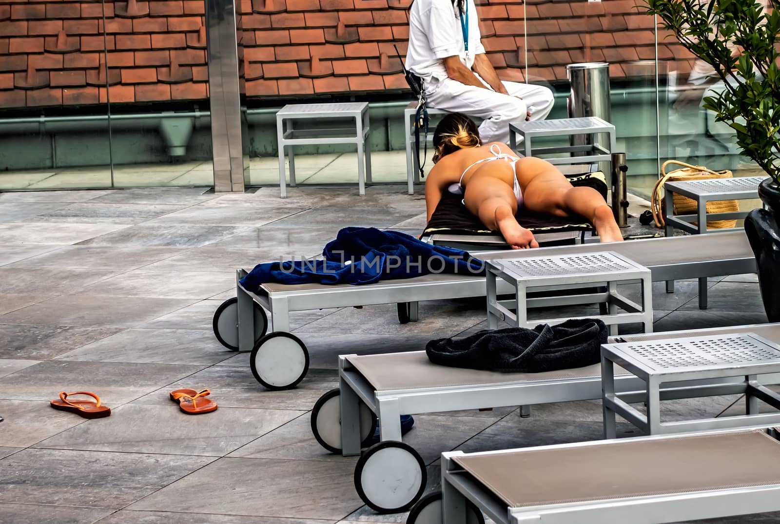 Rudas Bath Tanned Woman Relaxation On lounge chair Rooftop Medicinal Thermal Baths and Spa, Budapest, Hungary.