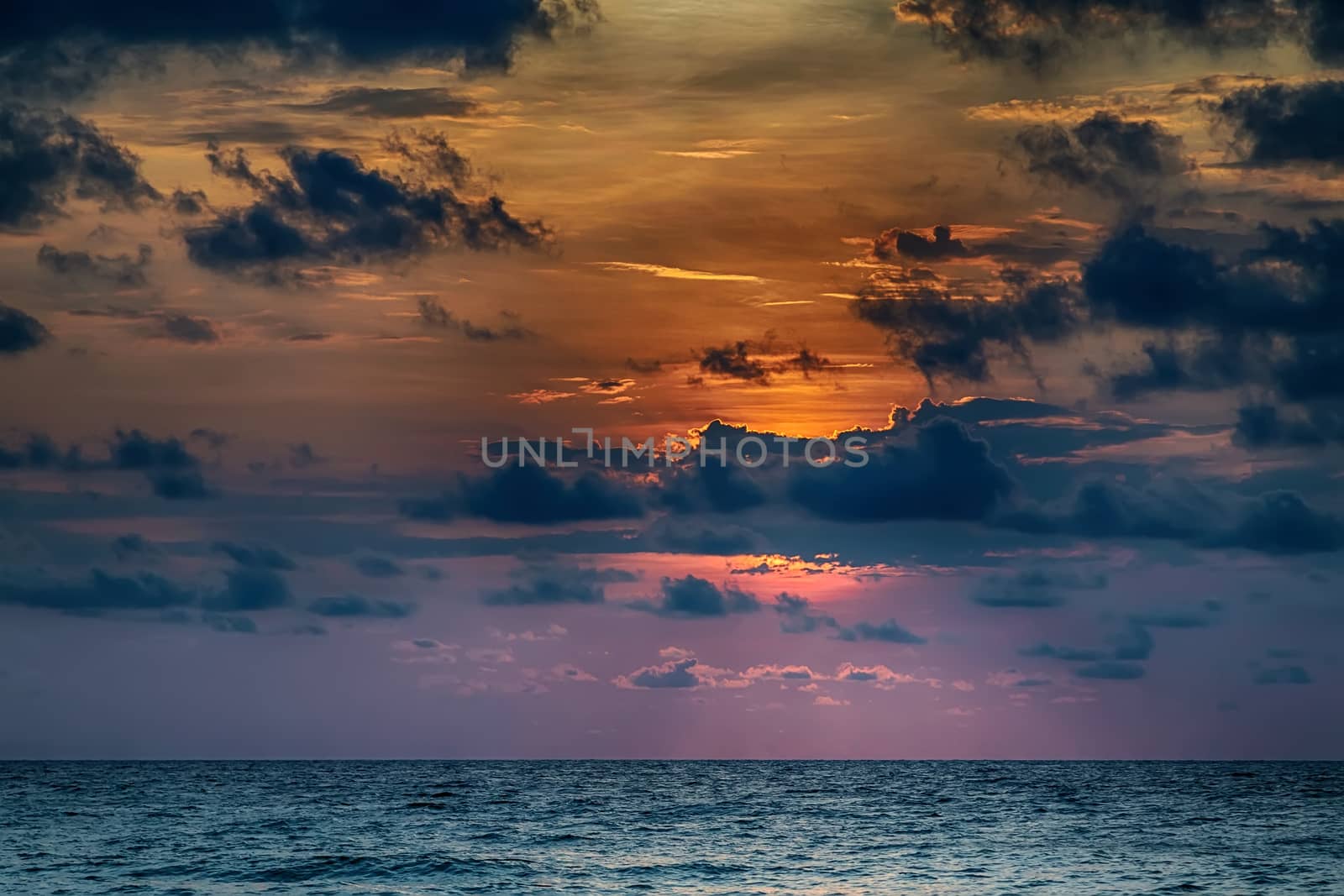 Sun with reflection in water clouds.