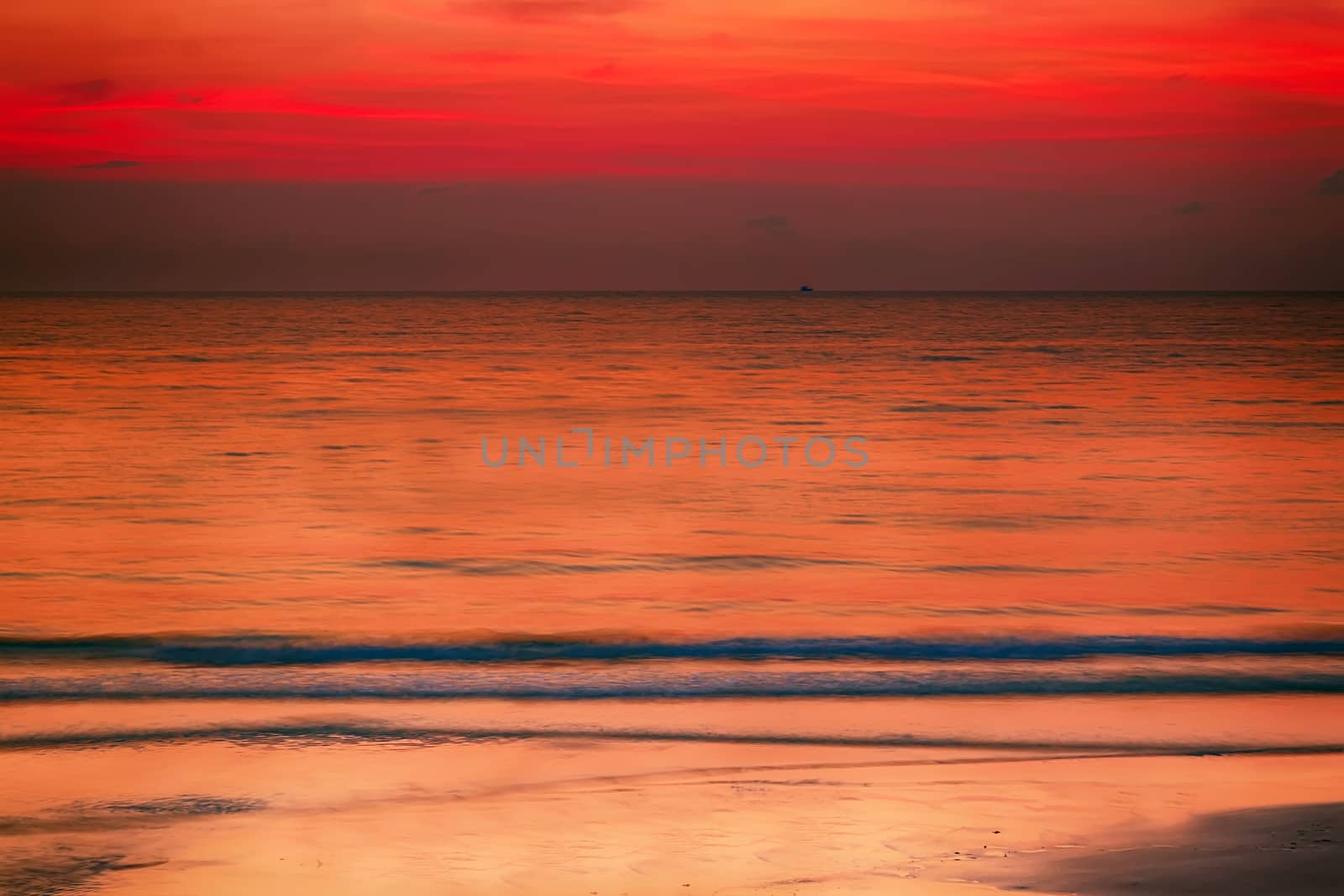 Summer background evening beach at sunset with waves