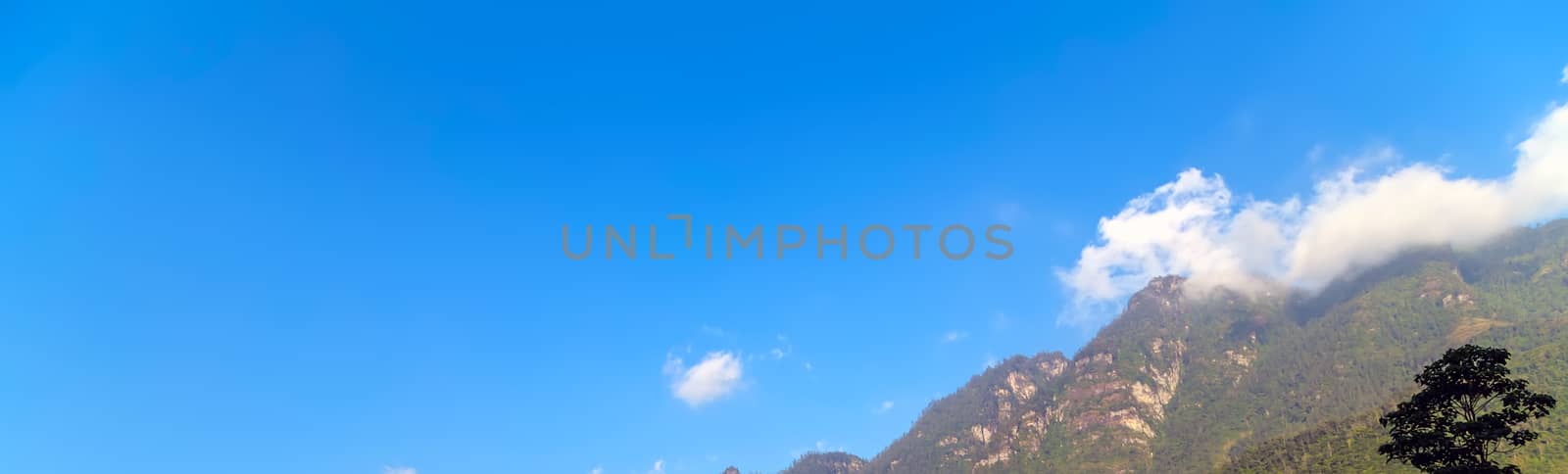 Green mountain range sky scene white clouds panorama.