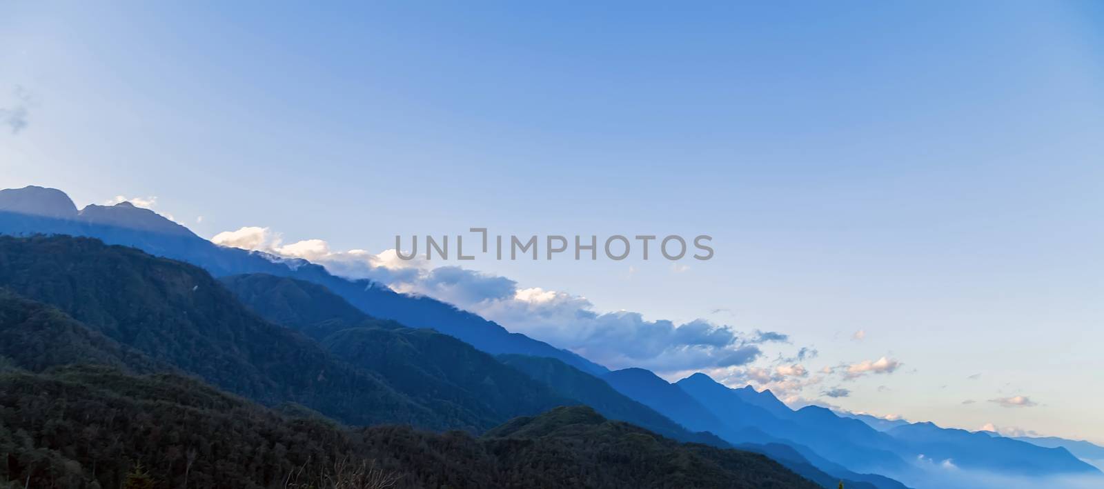 Mountains, mountain peak hill top nature landscape. Camping landscape and hiking travel adventure tourism. Amazing Sunrise over the mountain range.