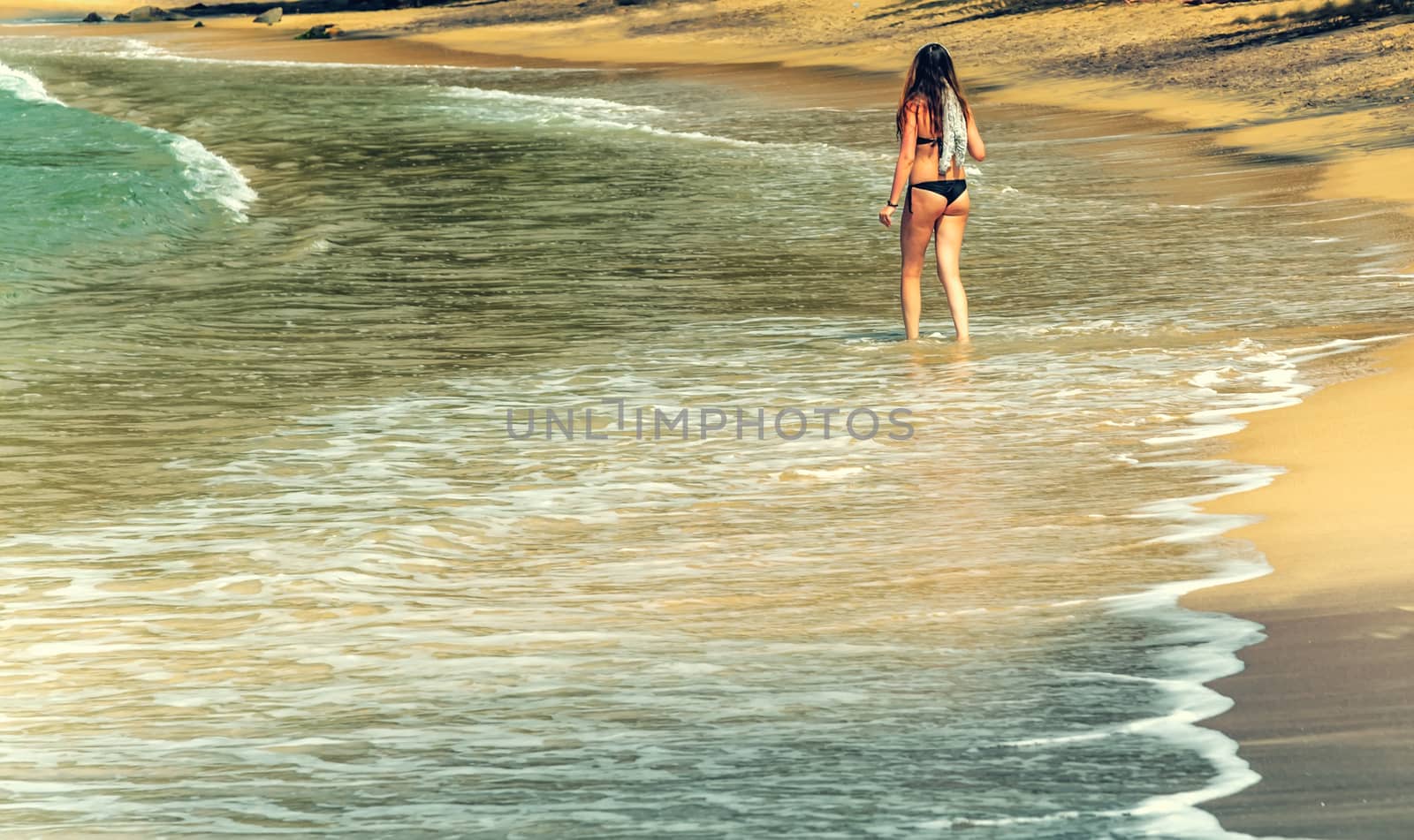 Summertime Woman in a Beach and bay World Water Day Vulcan black sand coast in the town of Mirissa, Sri Lanka. Save the water - ecology concept background
