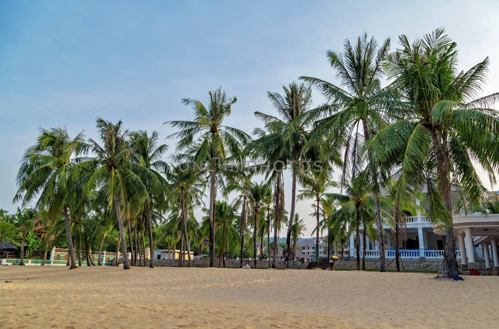 Summer Vacation and Holiday Trip Luxury resort hotel. Beach chair on sand beach blue sky in the background. Concept of travel and relax in paradise. Phu Quoc island in Vietnam.