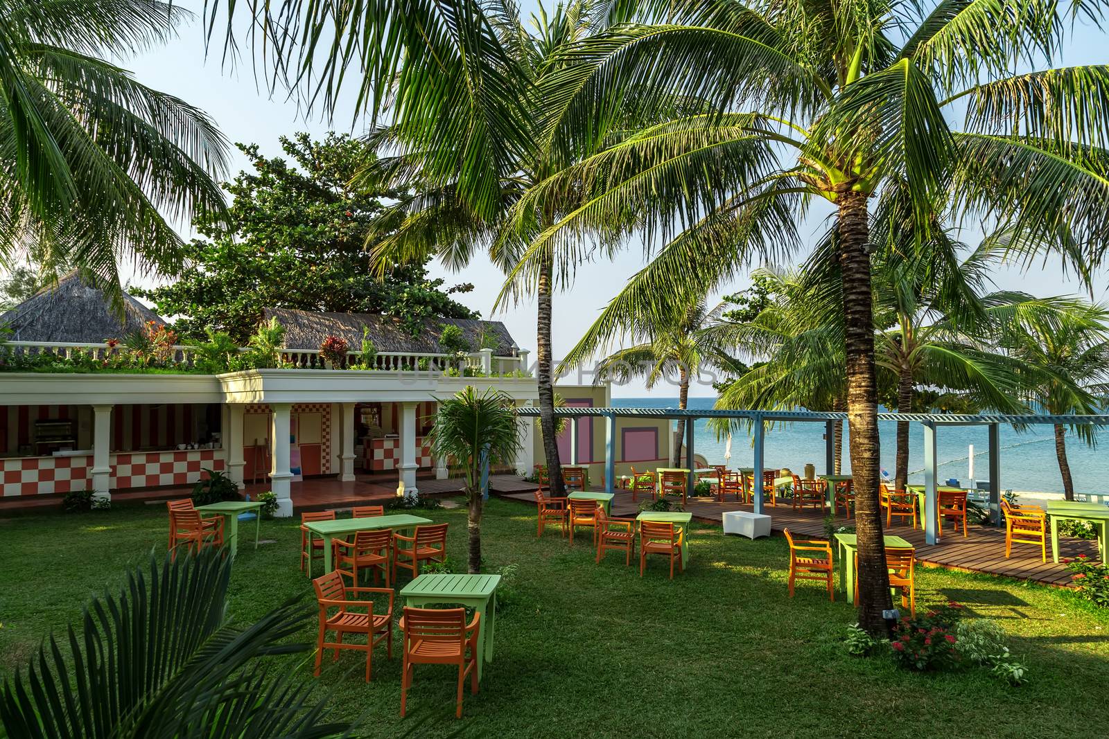 Phu Quoc island in Vietnam holiday vacation concept Summer background landscape of a tropical resort Bungalows shadow from a coconut tree.