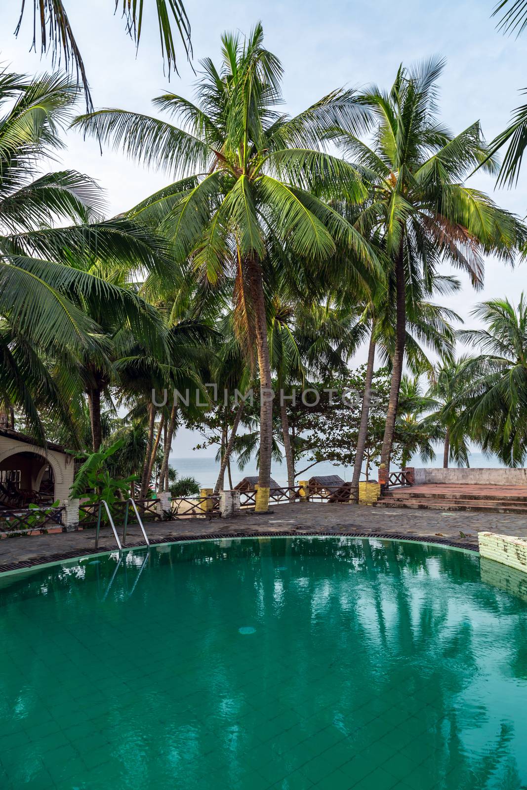 Tropical relax outdoorprivate swimming pool panoramic sea view at luxury villa. Poolside for relax. Silhouette coconut palm tree