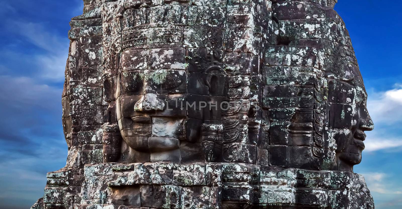 Khmer Smile Buddhist Stone face in Bayon Temple Angkor Thom, Cambodia. Ancient monument Khmer architecture.