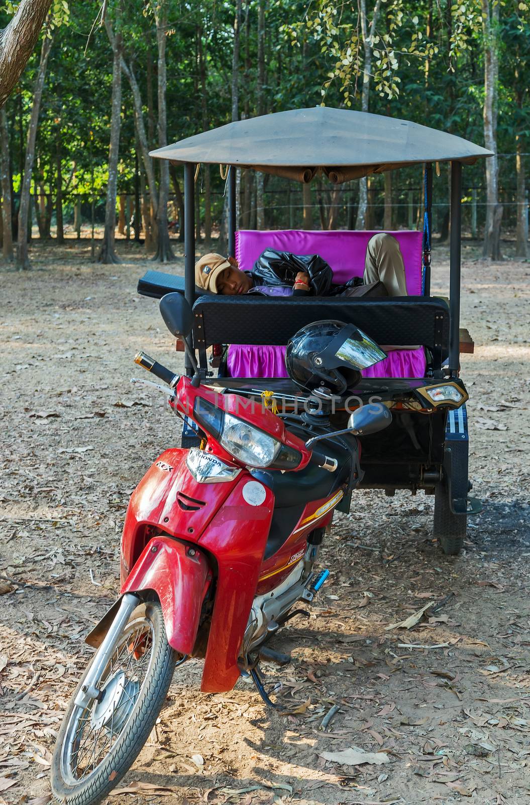 Siem Reap, Cambodia - 25 FEB, 2015: Asian rickshaw with no people in passes Taxi in Cambodia Tuk Tuk of Angkor Wat, Khmer temple complex, Asia.