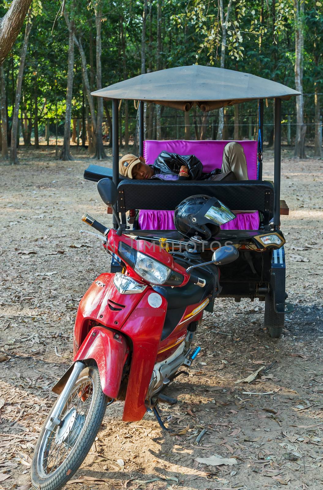 Siem Reap, Cambodia - 25 FEB, 2015: Asian rickshaw with no people in passes Taxi in Cambodia Tuk Tuk of Angkor Wat, Khmer temple complex, Asia.