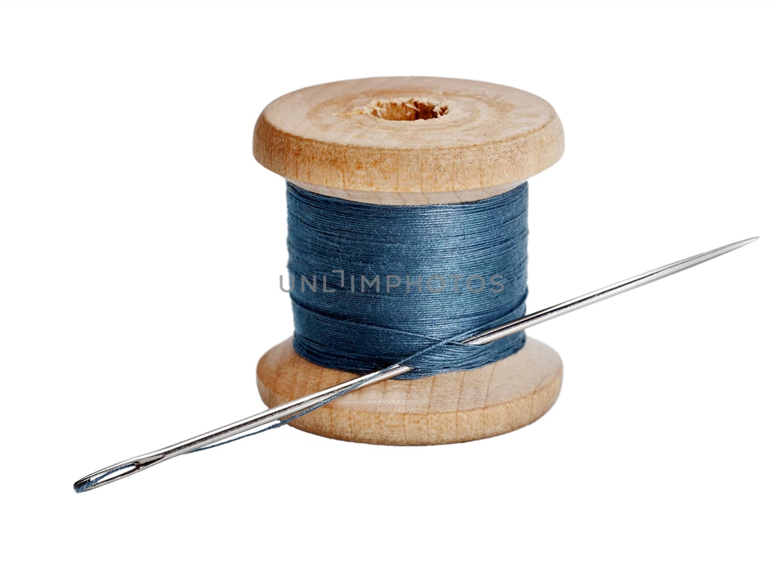 Needle and wooden spool thread isolated on white background