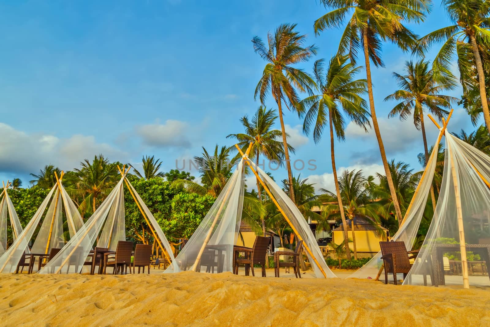gazebo on sandy island beach with coconut palm trees vacation concept