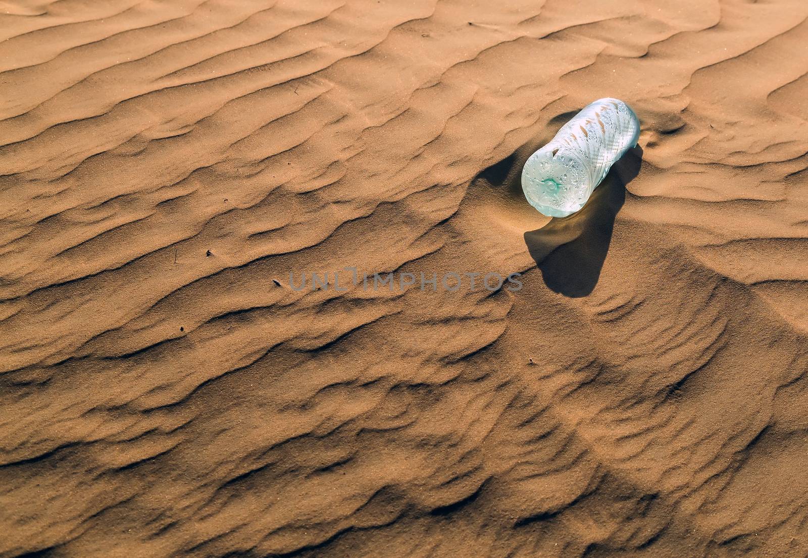 mineral water bottles in sand dunes eco concept nature landscape desert