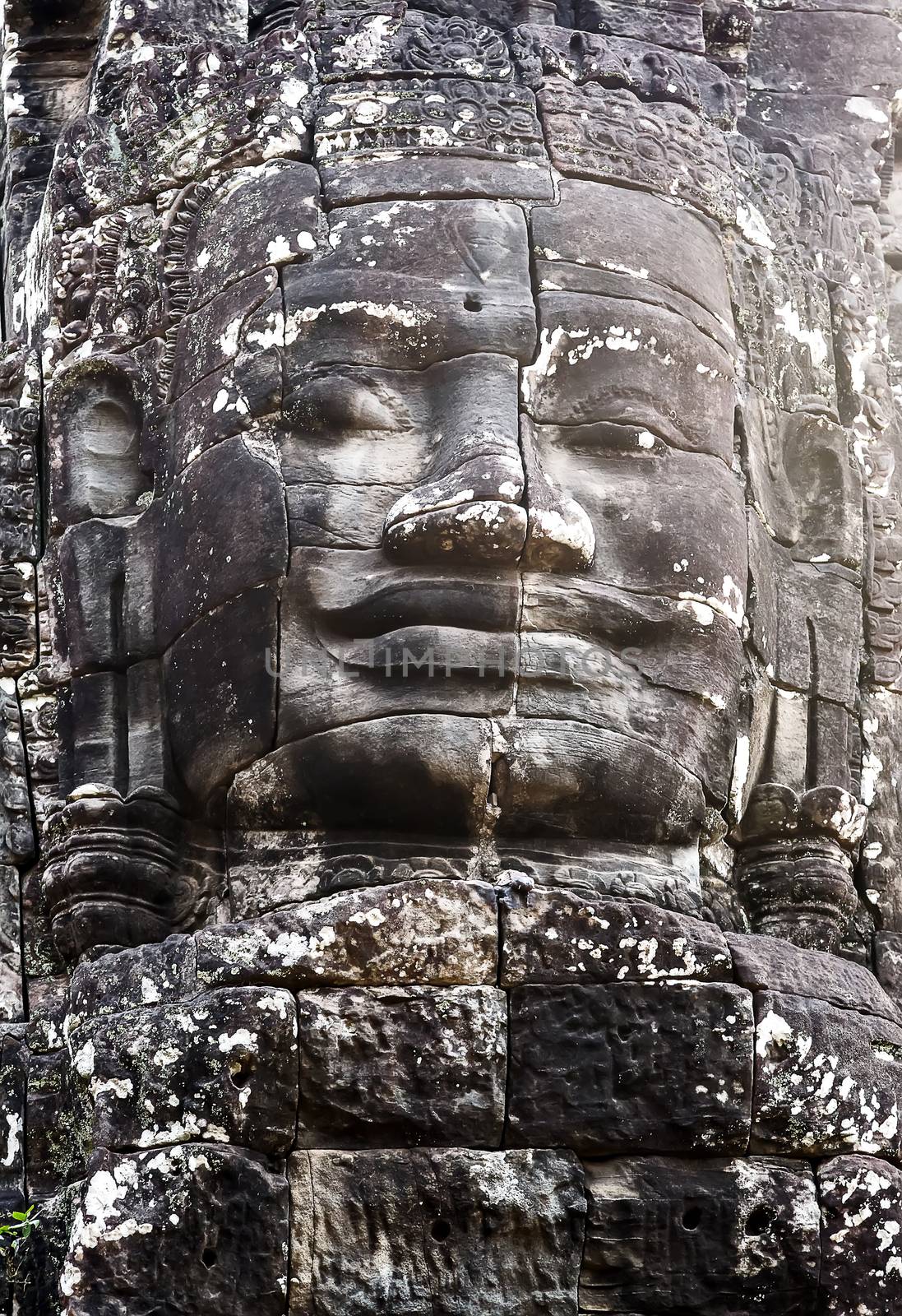 Buddhist Stone Khmer Smile face in Bayon Temple Angkor Thom, Cambodia. Ancient monument Khmer architecture.