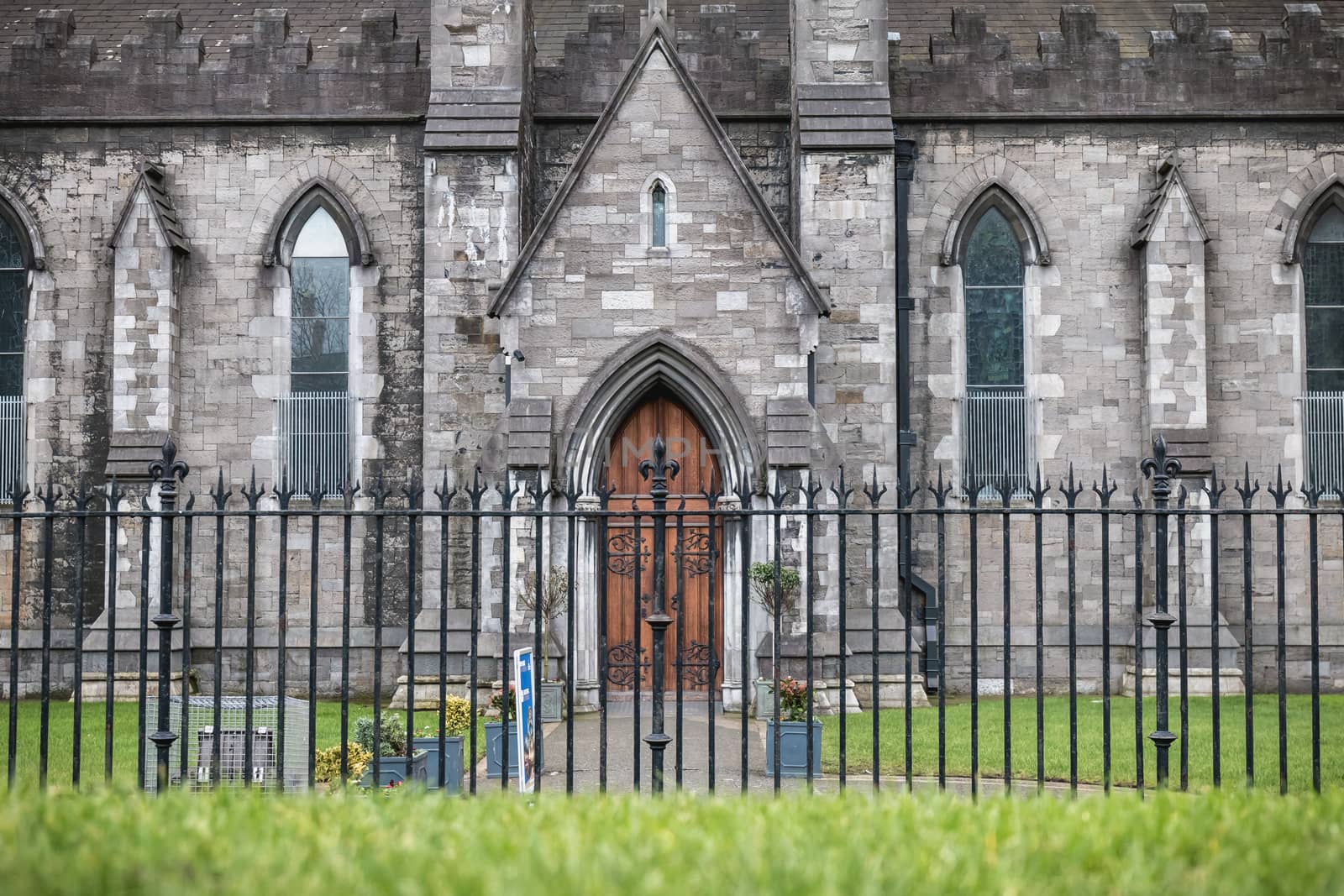 Dublin, Ireland - February 13, 2019: Street atmosphere and architecture of St Patrick's Cathedral that people visit on a winter day