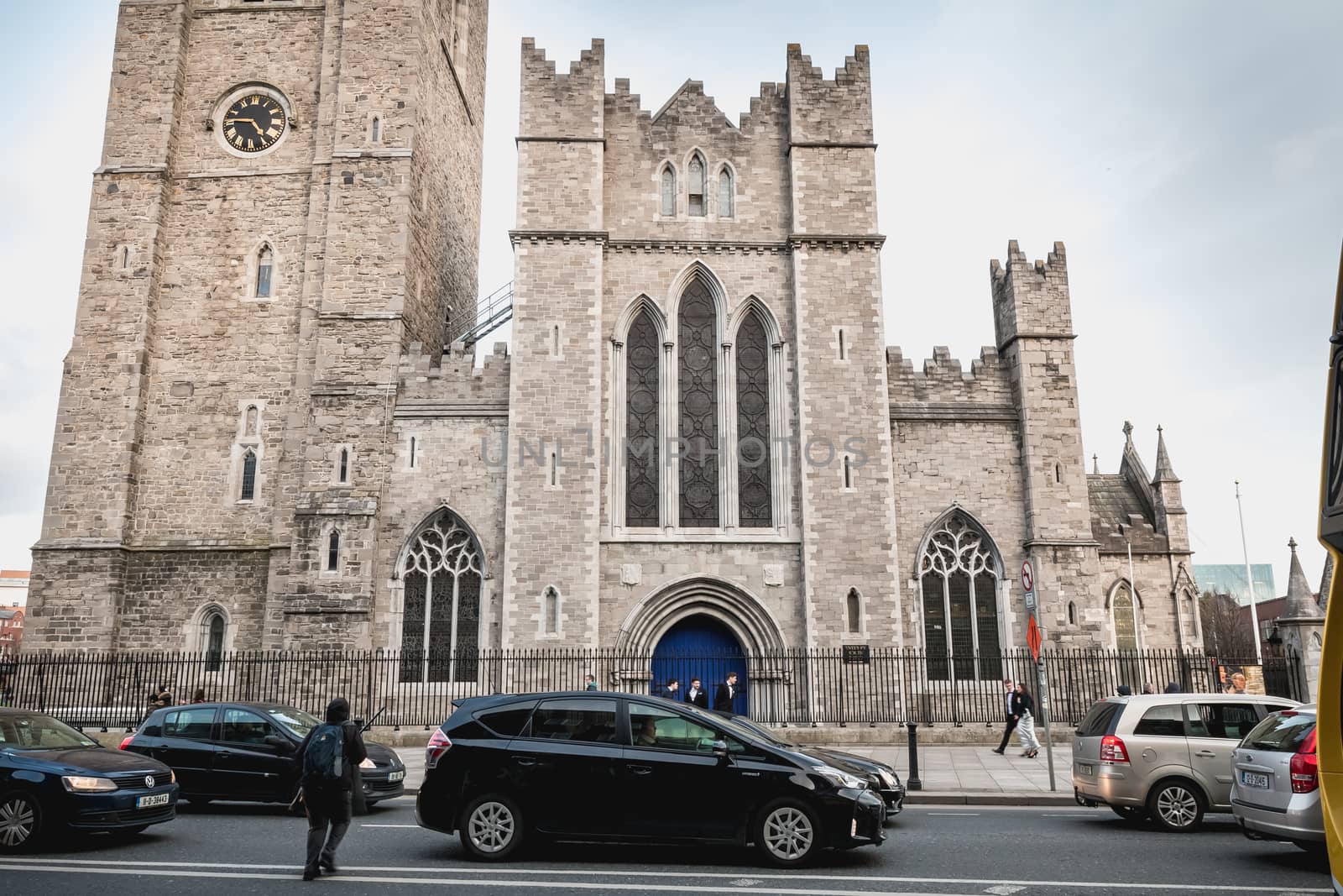 Dublin, Ireland - February 13, 2019: Street atmosphere and architecture of St Patrick's Cathedral that people visit on a winter day