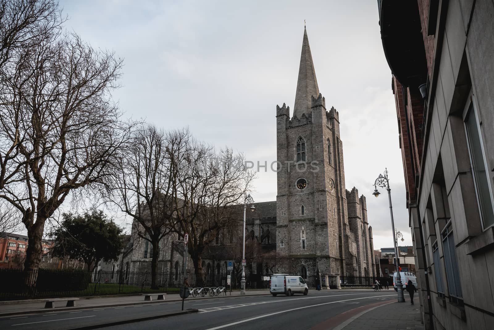 Dublin, Ireland - February 13, 2019: Street atmosphere and architecture of St Patrick's Cathedral that people visit on a winter day