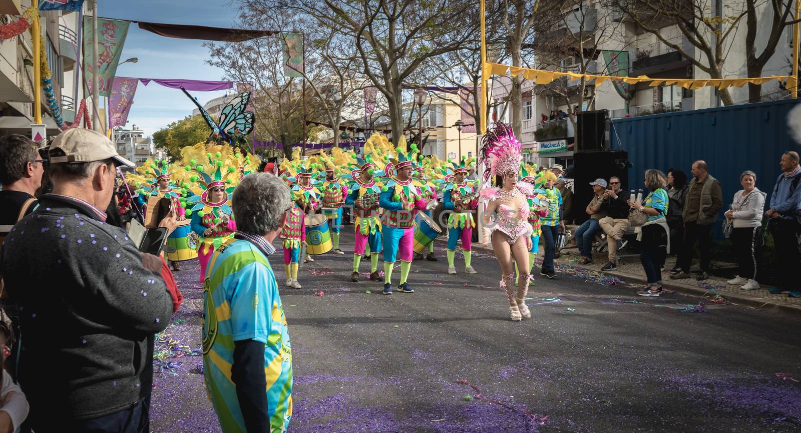 Loule, Portugal - February 25, 2020: percussionists parading in the street accompanying dancers in the parade of the traditional carnival of Loule city on a February day