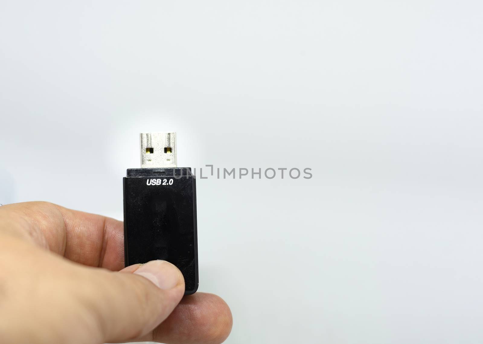 human male hand holding a USB flash memory on a white background. by rarrarorro