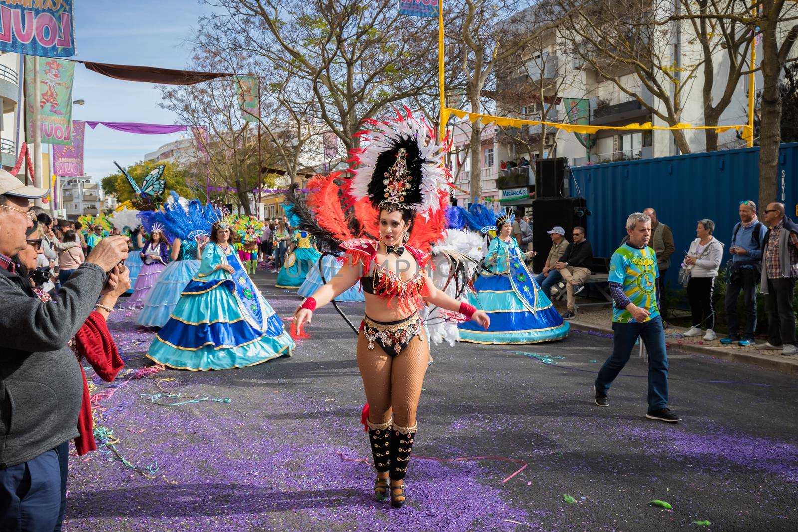 Loule, Portugal - February 25, 2020: dancers parading in the street in front of the public in the parade of the traditional carnival of Loule city on a February day