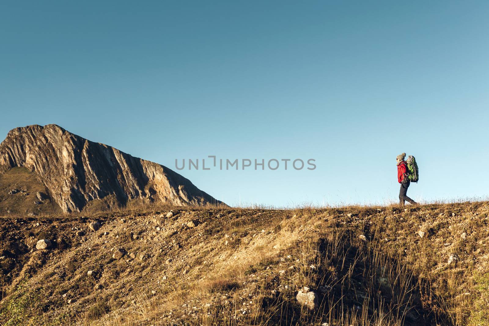 Shot of a woman exploring the montains with a backpack