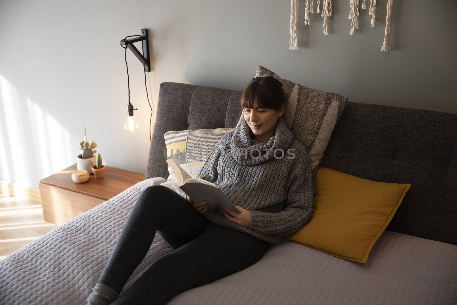 Beautiful woman on bed and reading a book