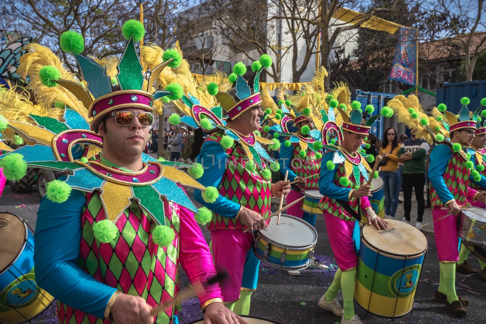 Loule, Portugal - February 25, 2020: percussionists parading in the street accompanying dancers in the parade of the traditional carnival of Loule city on a February day