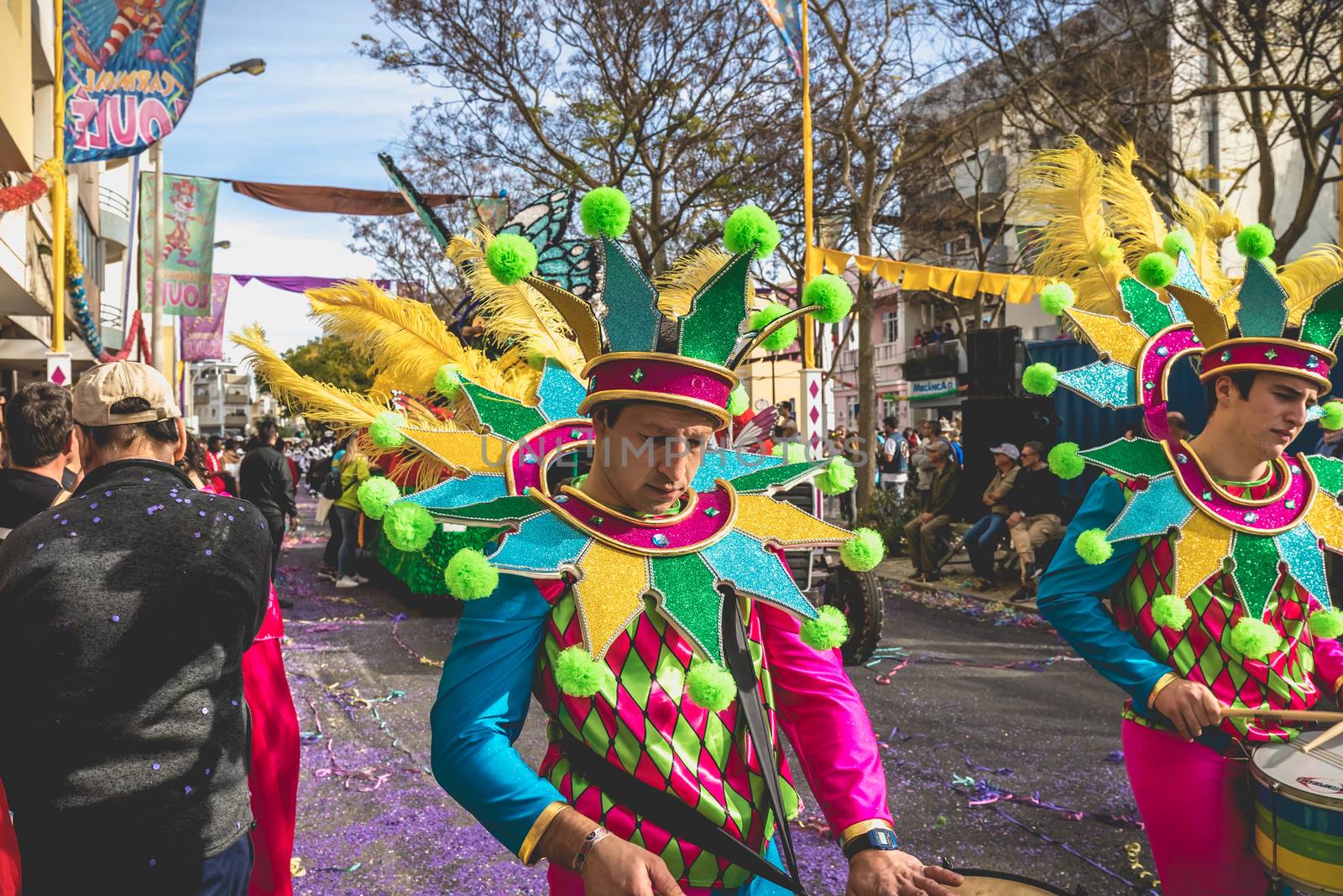 Loule, Portugal - February 25, 2020: percussionists parading in the street accompanying dancers in the parade of the traditional carnival of Loule city on a February day