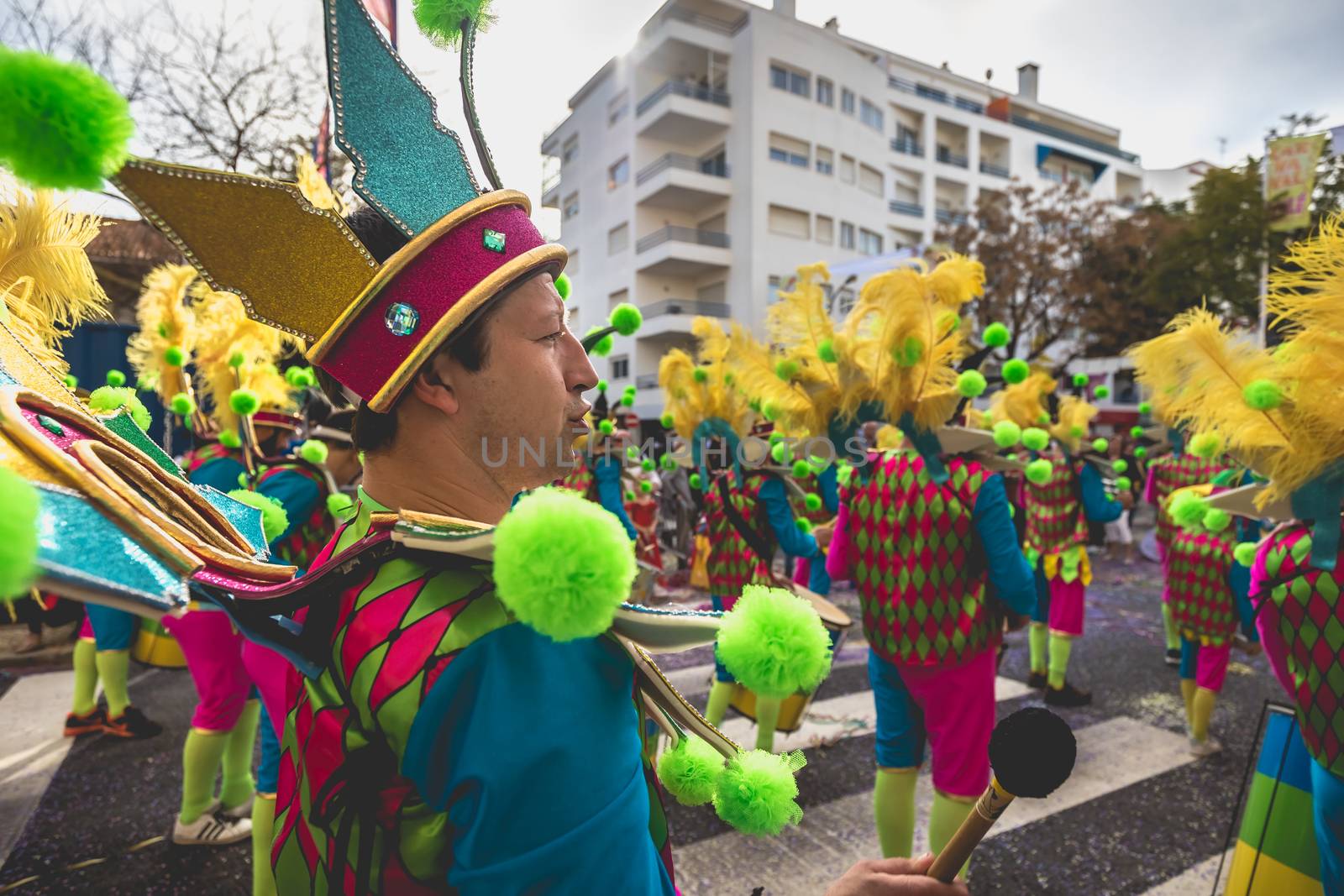 Loule, Portugal - February 25, 2020: percussionists parading in the street accompanying dancers in the parade of the traditional carnival of Loule city on a February day