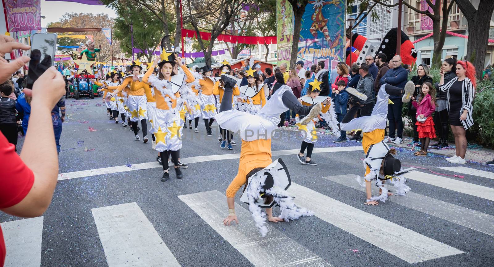 Loule, Portugal - February 25, 2020: dancers parading in the street in front of the public in the parade of the traditional carnival of Loule city on a February day