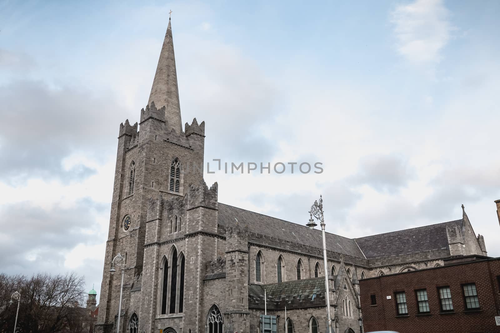 Dublin, Ireland - February 13, 2019: Street atmosphere and architecture of St Patrick's Cathedral that people visit on a winter day